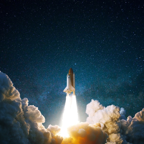 A rocket launching into a starry night sky
